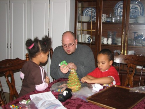 Uncle Ben devorating the gingerbread tree with Darius and Jazia.