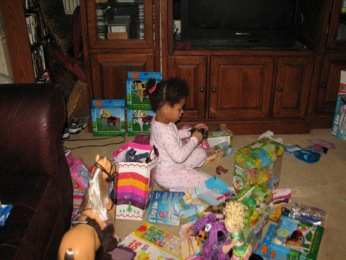Jazia surrounded by toys.